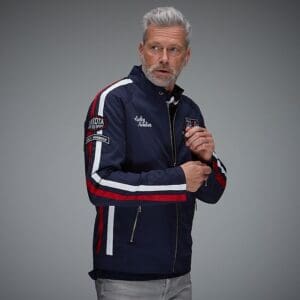 Man wearing a stylish navy racing jacket.